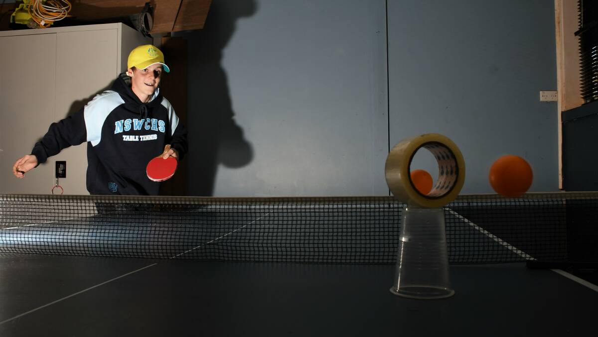 What a shot: Nick Rudd hits a ball through a roll of tape with another ball inside it. Photo: Matt Attard