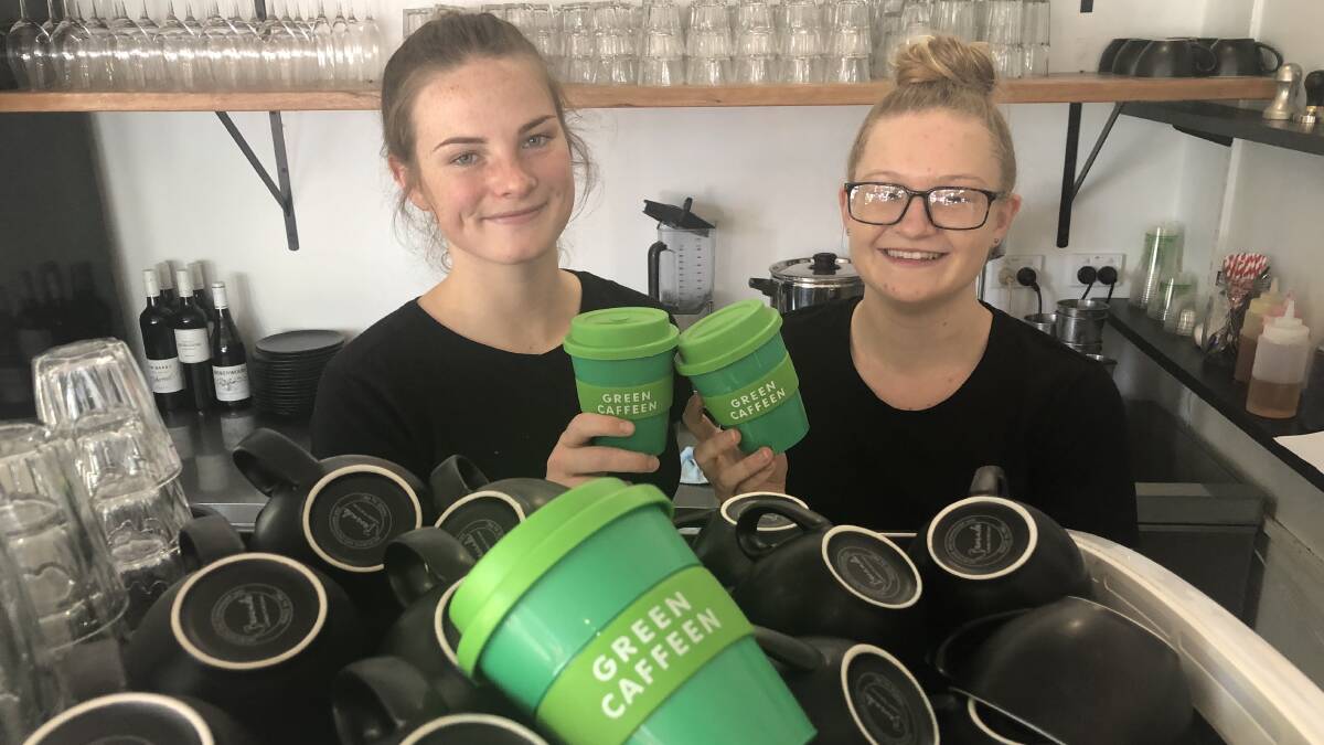 Go green: Beantree Cafe staff members Ebony Opdam and Lauren Heugh with Green Caffeen keep cups.