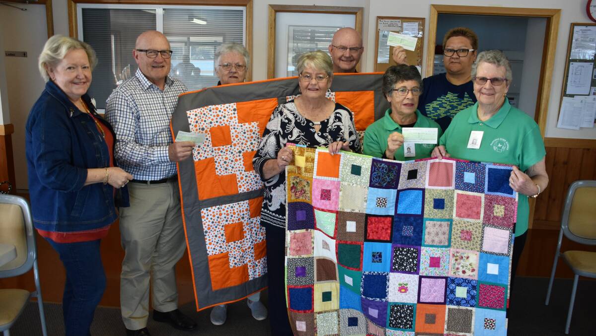 Big donations: Lee McGlasham, Hastings Education Fund chair Jim O'Brien, new president of Timeless Quilters Barbara Crook, outgoing president Sue Jenner, Endeavour Mental Health representative Rob Moorehead, Marita Crighton and Lillian Andrews from Hastings Home Hospice and Bec Williams.