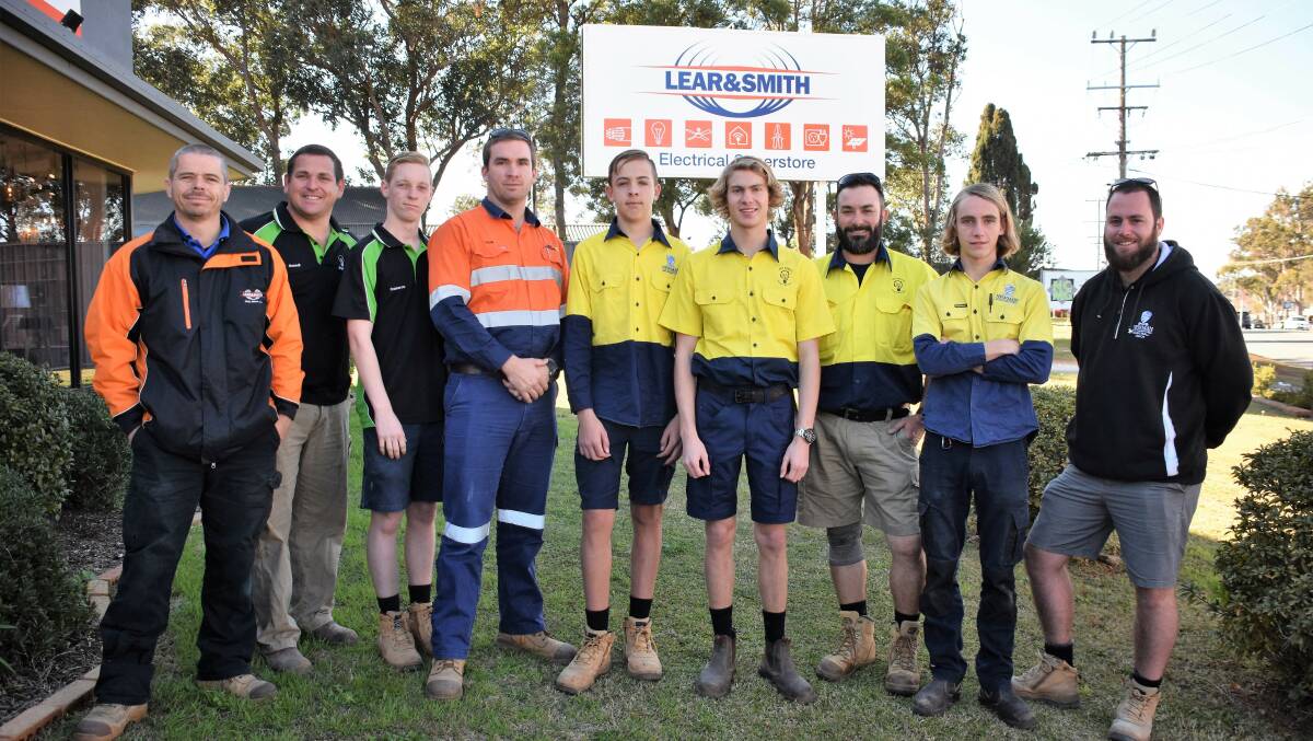 Happy to help: Lear and Smith team members with Newman students and local tradesman. 