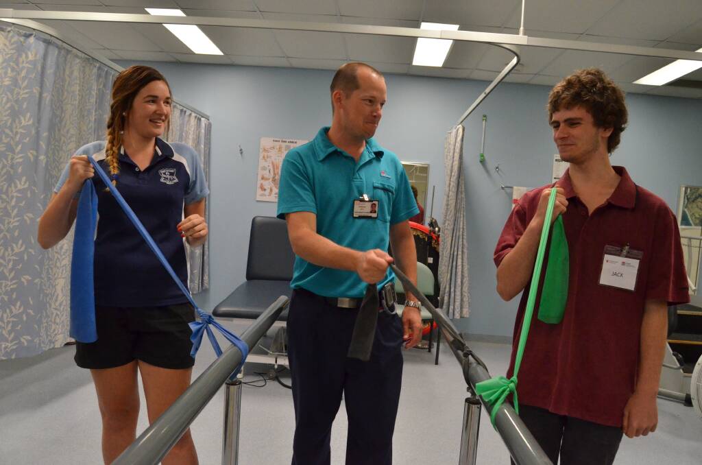 Strong future: Physiotherapist in charge Anthony Best (centre) shows Wauchope High School students Aaliyah Postle and Jack Jones how to use resistance bands for muscle strengthening during their tour of Port Macquarie Base Hospital.