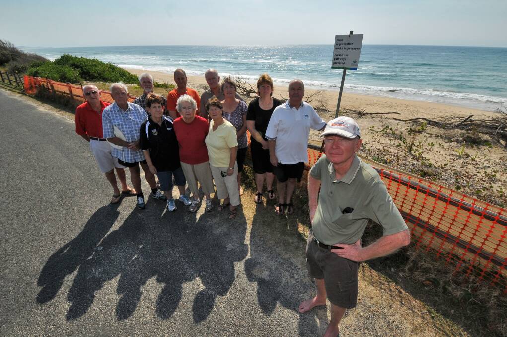 Coastal concerns: (back) Graham Denton, Russel Seccombe, Greg Smith, Steven Hunt, Brian and Sandra Tobin, Judith and Tam Grant, (front) Mary Baylis, Ann Seccombe, Jan Denton and (right) Malcolm McDonald gather in Illaroo Road after the sub-committee's decision.