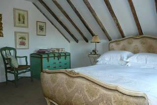 Simply French...exposed timber beams in the bedroom.