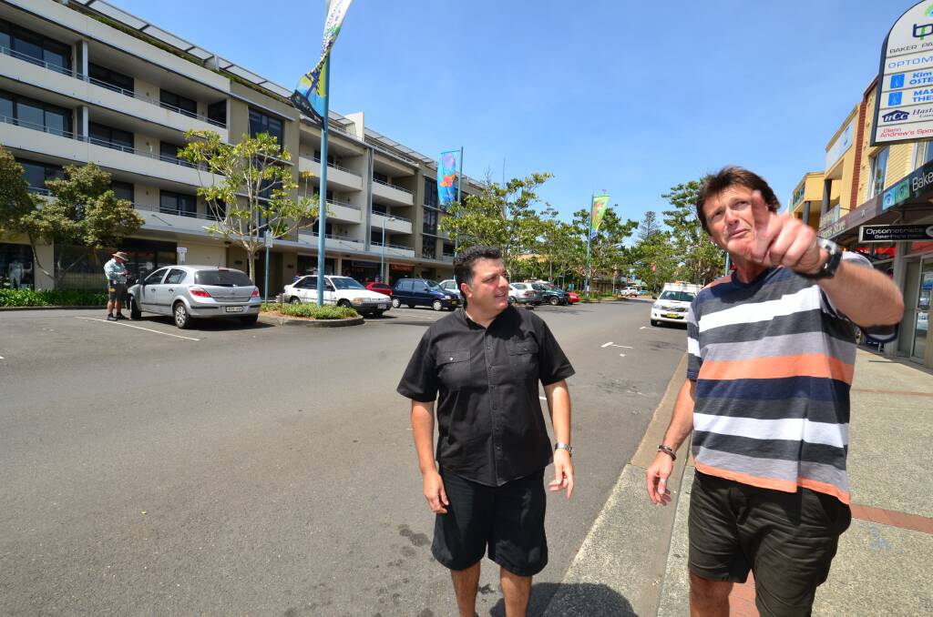 Parking talks: Cafe 66 owner Phillip Saltafosso (left) and Andrew’s Sports Store owner Glenn Andrew share their thoughts about parking time limits as a council ranger books someone in the background