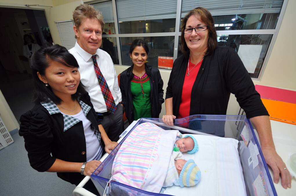 Nepalese midwives Sonam Sherpa and Jyoti Chaulagain with Dr Roy Hodgson and clinical midwifery specialist Louise Harper checking on twins Jessie and Poppy Delaforce.  