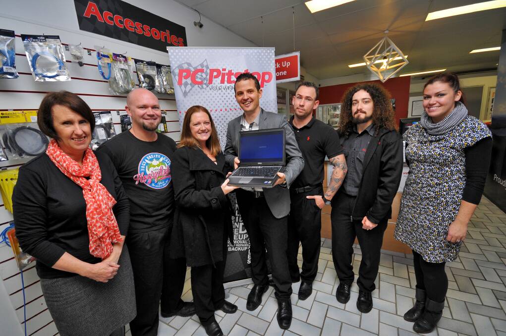 Communication lifeline: Parents Mick and Tara Knowles (second and third from left) receive the computer from PC Pitstop owner Ben Waters as Port Macquarie MP Leslie Williams (left) and the PC Pitstop team of Tristan Piper, Ben Stelzer and Samantha Clark look on.