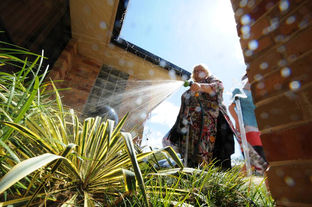 Rain needed: Angela Johnson of Wauchope watering her garden yesterday. Council could be forced to consider stricter water restrictions  without decent rain over the next month. Pic: Peter Gleeson