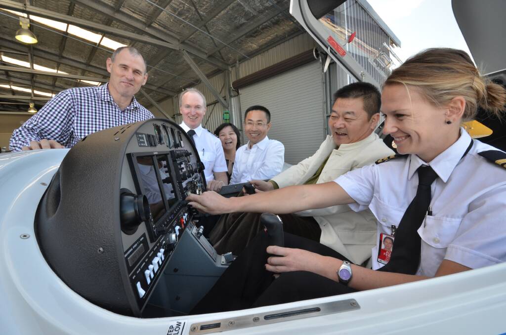Mayor Peter Besseling, chief pilot Kevin McMurtrie, Arena International Aviation’s Li Li, Tian Wei from Hainan Airlines Group, Arena International Aviation chairman Li Chunming and flight instructor Ashlee Hayes inspect one of the new Diamond aircraft.
