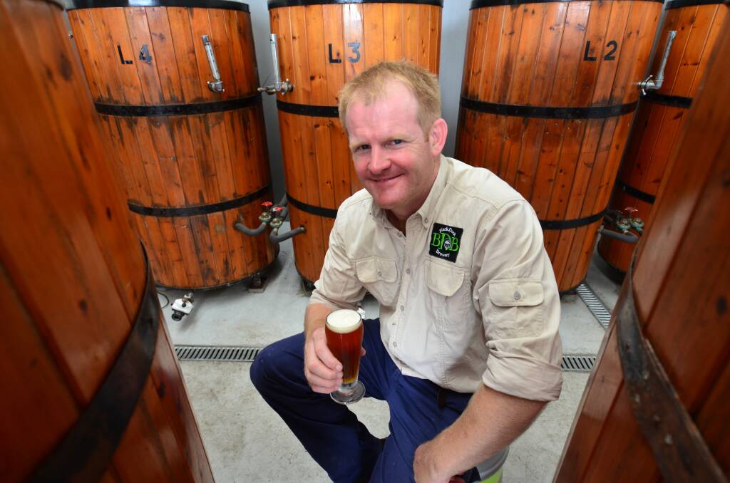 Barrel of fun: Black Duck Brewery owner Alistair Owen is pleased with his cellar door so far. Inset: Black Duck Brewery owner Alistair Owen at his new cellar door with three of his beers. 