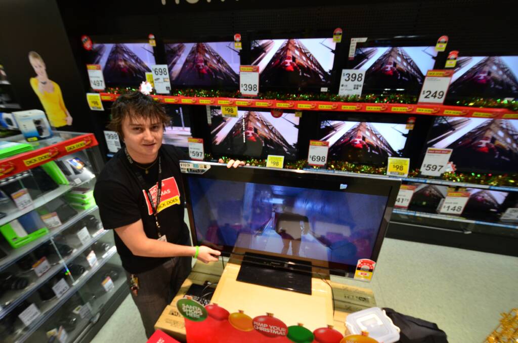 Find your fit: Dick Smith Settlement City store manager Tyron Searle shows off the TV display.  