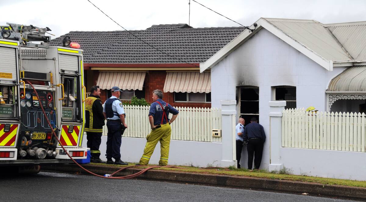 Fire crew inspect the damage to the house in Gore Street this morning.