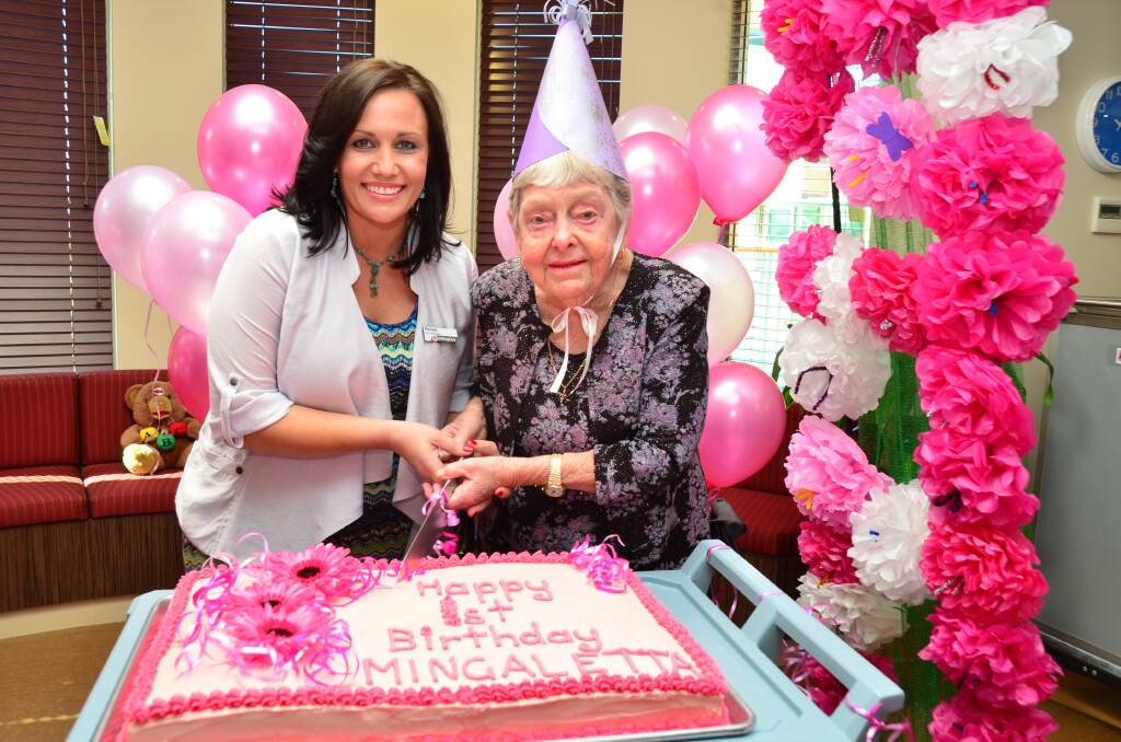 Mingaletta service manager Renee Yates with the facility's first resident Eva cutting the cake.