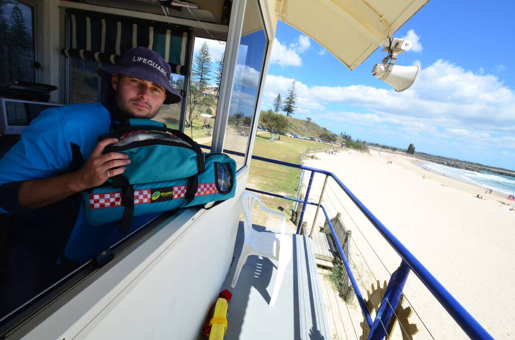 Trouble in paradise: Town Beach lifeguard Dane McCabe looking out the broken window of the tower with the oxy-viva resuscitator the service had to borrow from Flynns Beach just to make sure beach-goers were safe in an emergency.