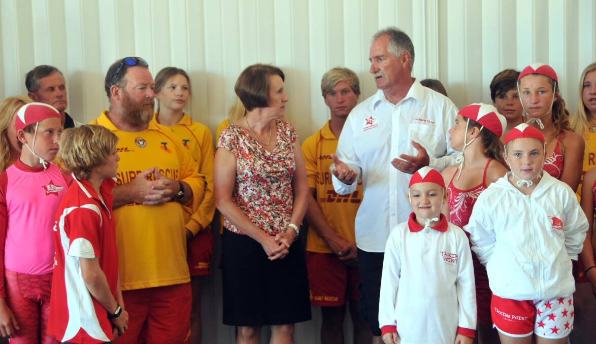 Over the moon: Tacking Point Surf Life Saving Club president Pat Staunton, Port Macquarie MP Leslie Williams and life member Mick Lang discuss the funding announcement as members look on.