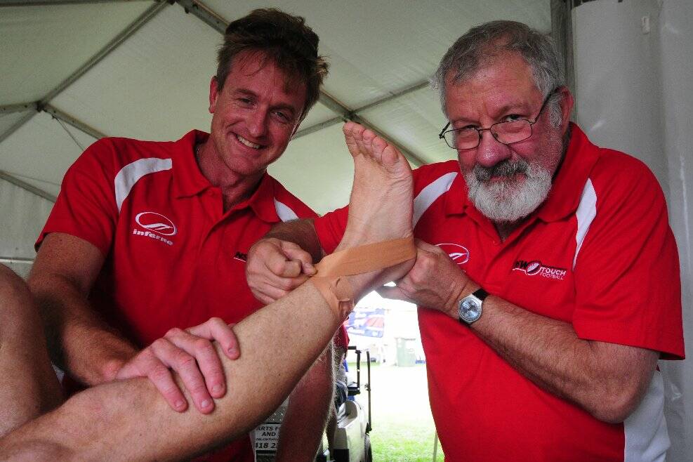 Physiotherapist Steve Cunningham, left, and Dr Martin Jaffe prepare to strap another patient at the State Cup. Pic: Matt McLennan