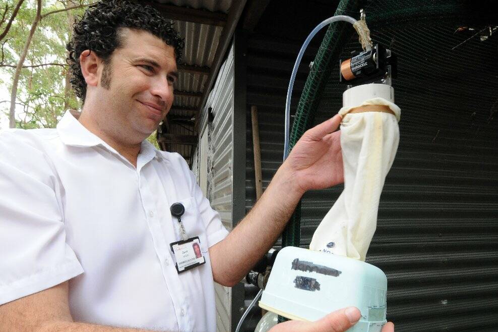 Fight the bite: Environmental health officer David Basso checks a mosquito trap.