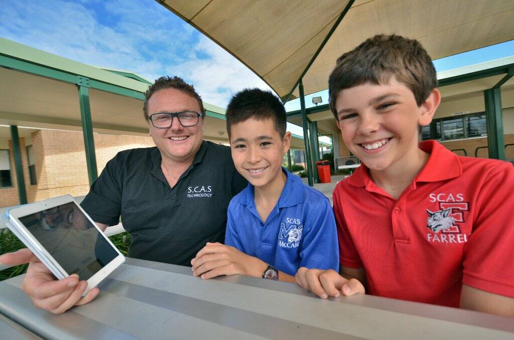 How to avoid the pitfalls: Matt Richards discusses anti-bullying procedures on the iPad with Gregory Mitchell and Hugo Bittar. Pic: Matthew Attard