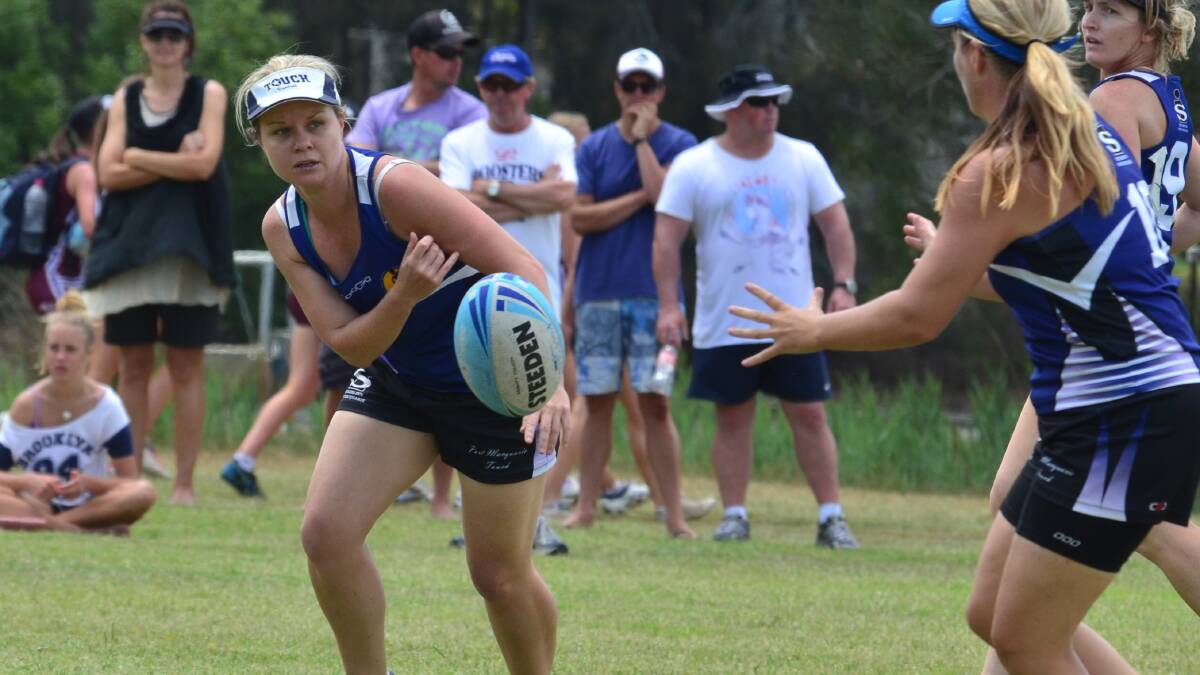 Kate Cowan gets a ball away for Port Macquarie's women's 30s team.