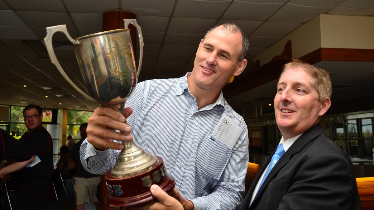 Port Macquarie-Hastings mayor Peter Besseling, left, and NSW Touch Association general manager Dean Russell with the State Cup from 1973. Pic: NIGEL McNEIL