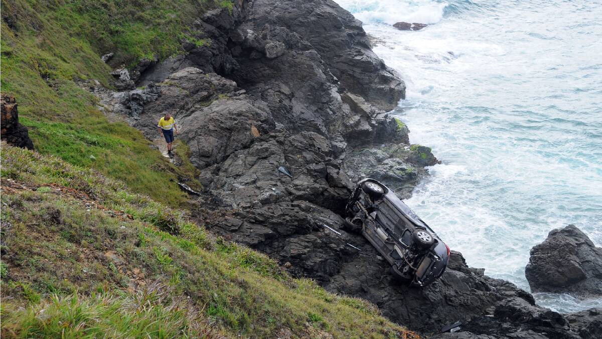 The car lies at the bottom of the cliff near Tacking Point Lighthouse
