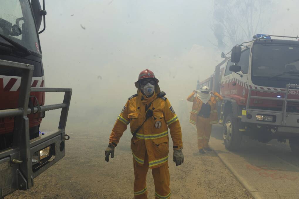 Rural Fire Service volunteers fight a grass fire on Andrews St, Penrith, west of Sydney. Photo: Mick Tsikas