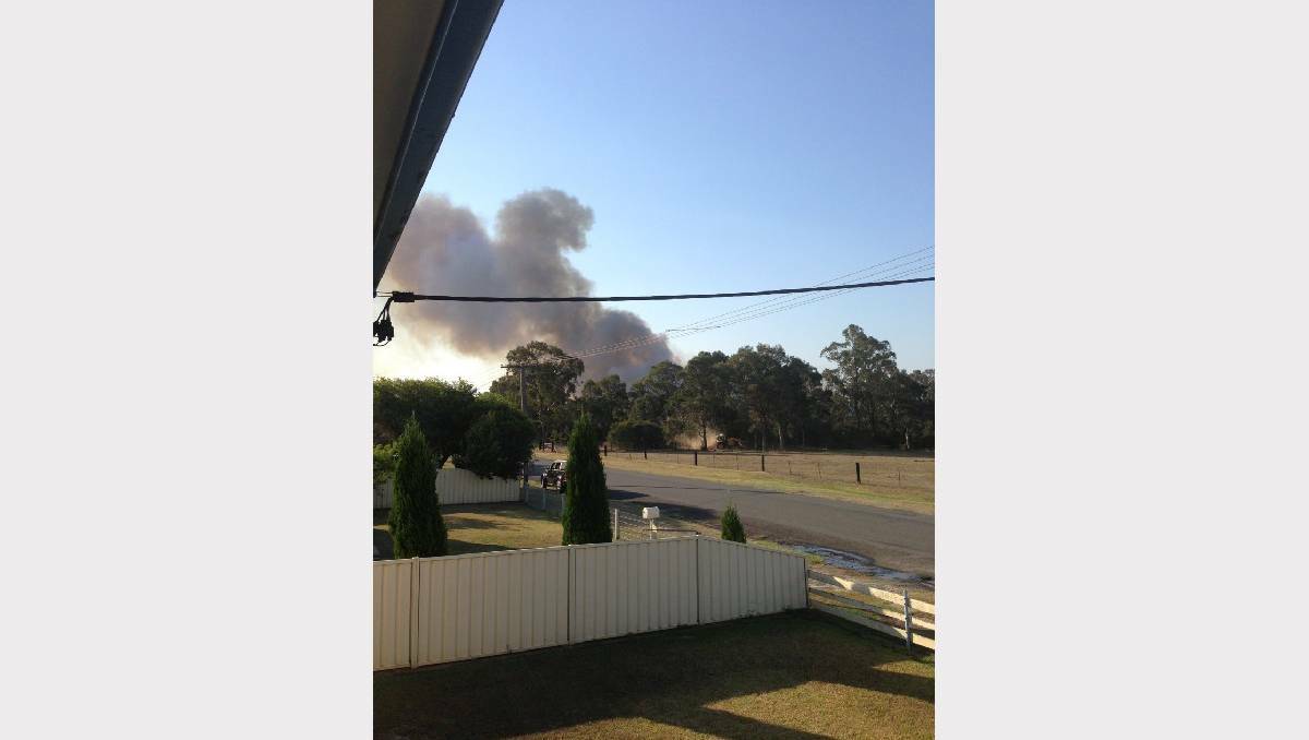 WORRY: Thick smoke soars over Melbourne Street, Cessnock yesterday afternoon.